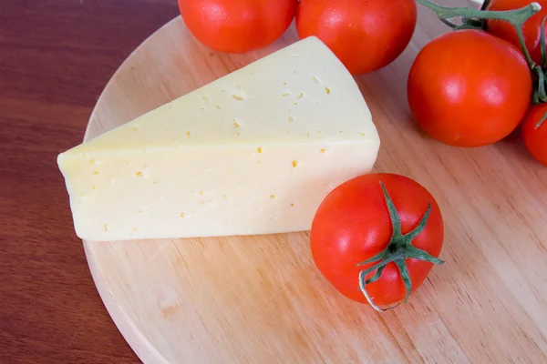 Yellow cheese with tomatoes — Stock Photo, Image