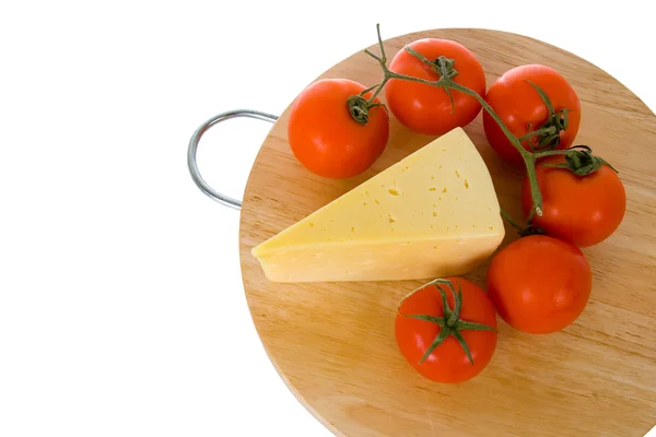 Yellow cheese with fresh tomatoes — Stock Photo, Image