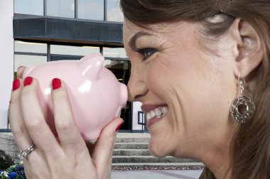 Woman holding piggy bank clipart