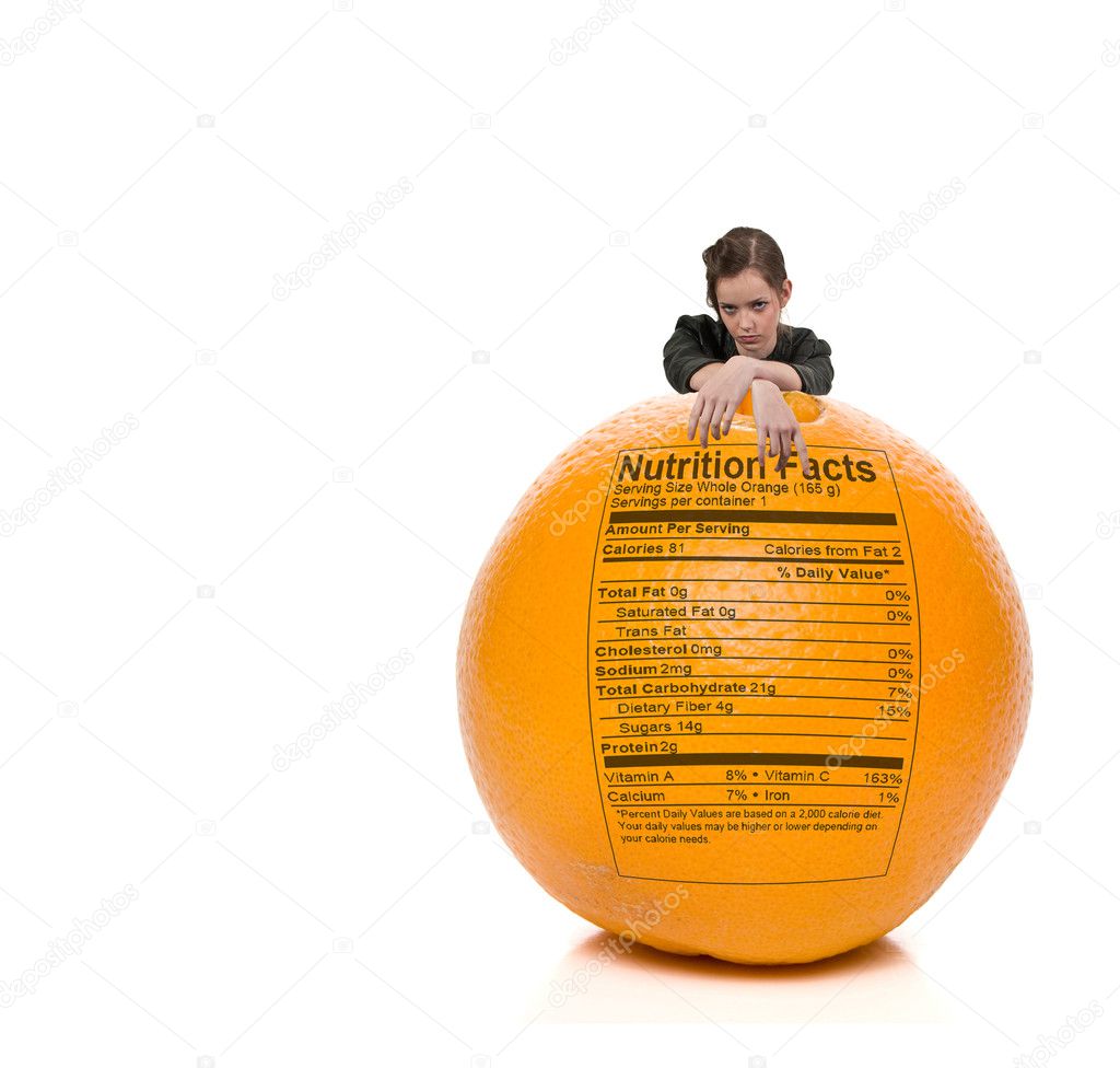 Teenage Woman Standing Behind Orange with Nutrition Label