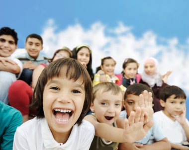 Crowd of children, different ages and races in front of the scho clipart