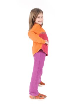 Cute little girl standing in studio clipart