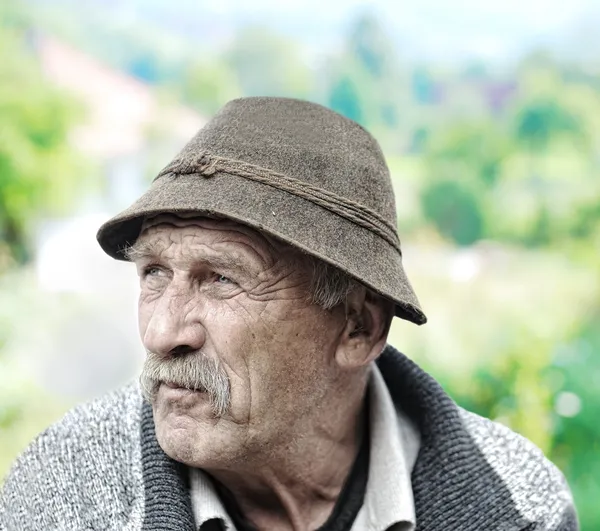 Elderly man's face over white background — Stock Photo, Image