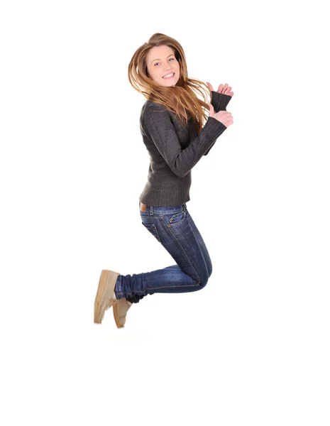 Flickan hoppar av glädje över vit bakgrund — Stockfoto