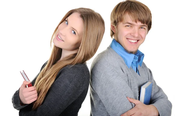 Jonge mannelijke en vrouwelijke studenten houden van boeken en permanent rug aan rug — Stockfoto