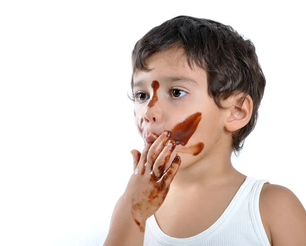 Criança com chocolate no rosto e mãos — Fotografia de Stock
