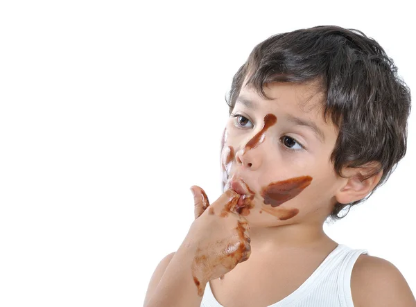 Cute kid with chocolate on his face — Stok fotoğraf