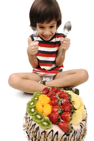 Kid eating fruit cake — Stock Photo, Image