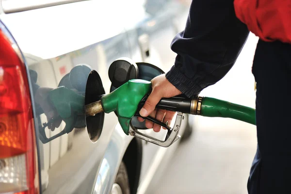 Image en gros plan d'une main d'homme remplissant la voiture avec une pompe à essence — Photo