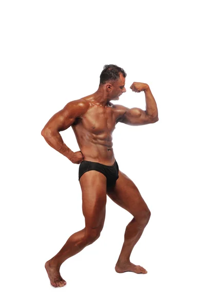 Человек-мускул позирует Лицензионные Стоковые Изображения