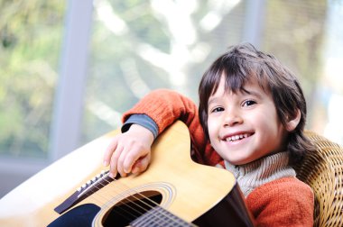 My son playing guitar at home clipart