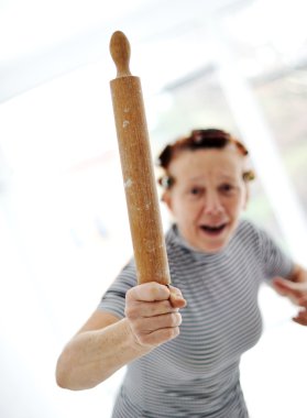 Angry older woman with rolling pin clipart