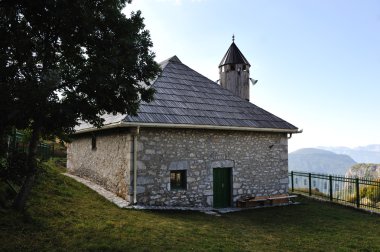 Old small mosque in mountains clipart