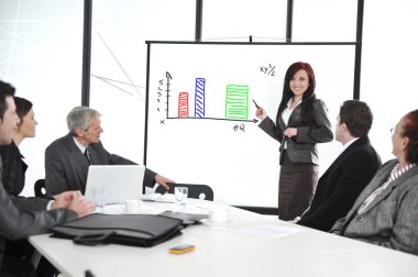 Business meeting - group of in office at presentation with flipchart clipart