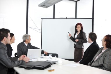 Business meeting - group of in office at presentation clipart