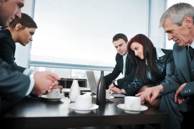 Portrait of director having coffee in office meeting clipart