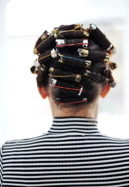 Mulher com encrespadores na cabeça, costas — Fotografia de Stock