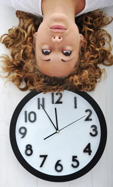 Girl and clock upside down — Stock Photo, Image