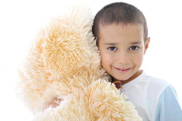 Portrait of a little kid hugging his teddy bear toy isolated in white — Stock Photo, Image