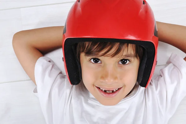 Kleiner süßer Junge mit Helm auf dem Kopf liegt entspannt — Stockfoto