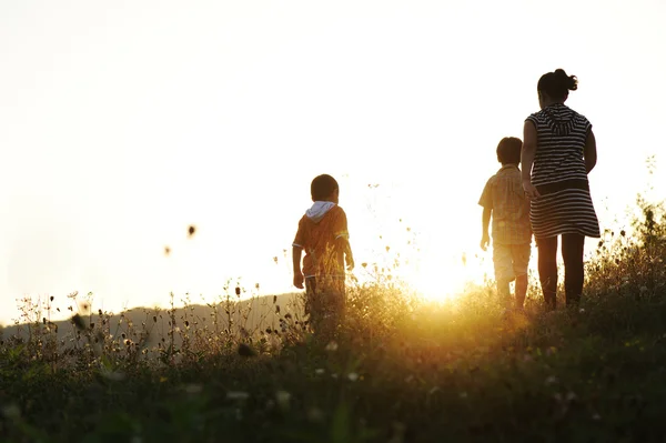 Happy children in nature at sunset — Stock Photo, Image