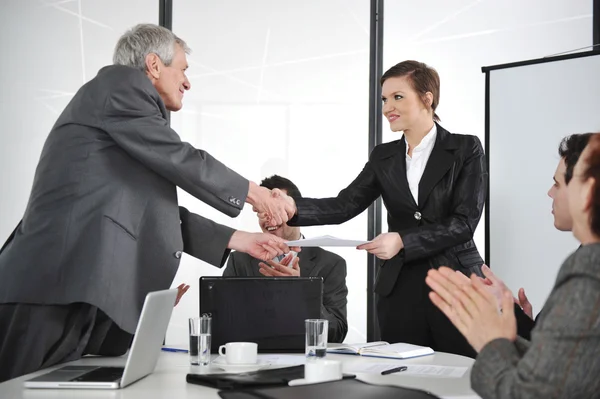 Business partners handshaking at meeting and receiving applause — Stock Photo, Image