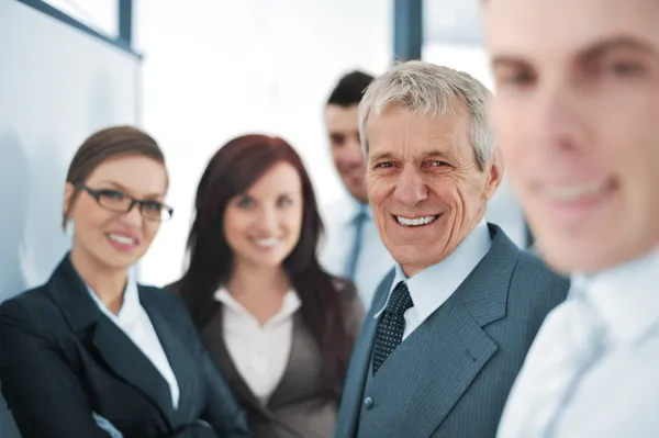 Small business team in the office in front of a whiteboard — Stock Photo, Image