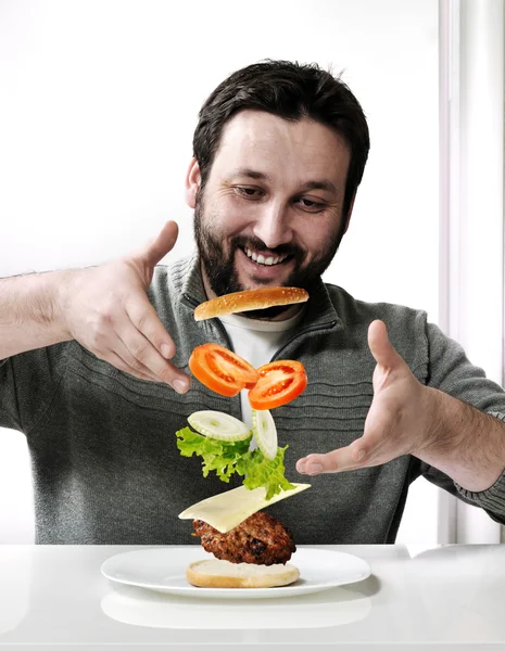 Adult man making a burger — Stock Photo, Image