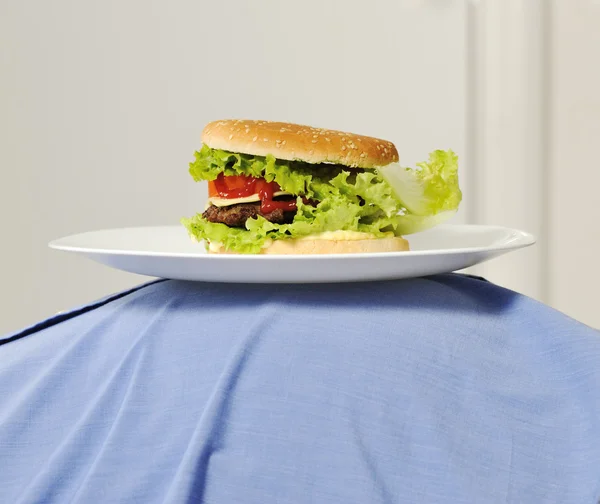 Burger on fat belly — Stock Photo, Image