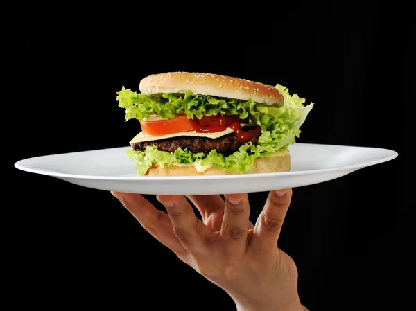 Burger on plate at restaurant — Stock Photo, Image
