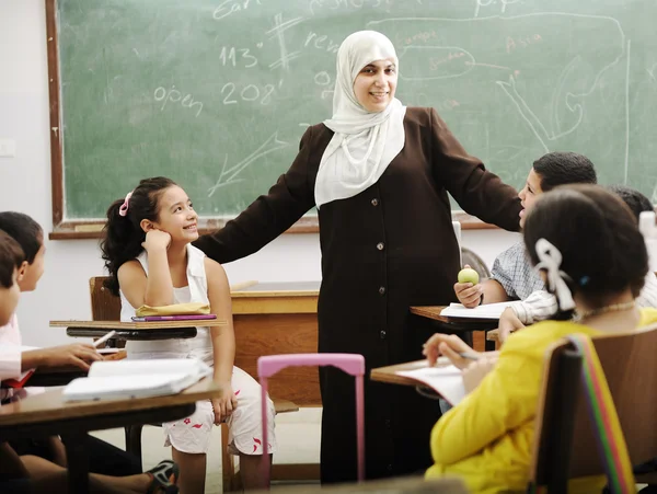 Muslim arabic children with teacher at school — Stock Photo, Image