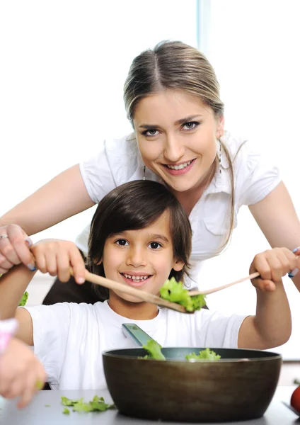 Beautiful mother and little son in kitchen together Stock Image