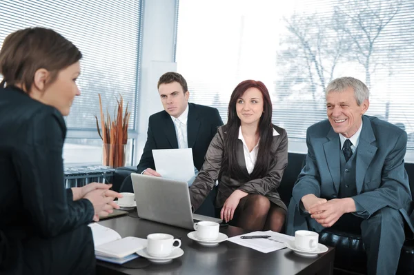 Businesswoman in an interview with three business getting positive feedback — Stock Photo, Image