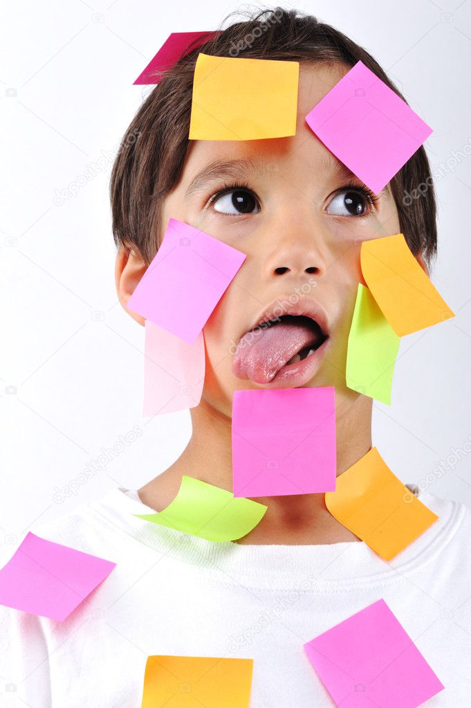Little boy with memo notes on his face