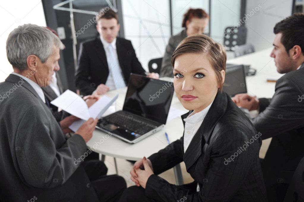 Portrait of successful businesswoman and business team at office meeting
