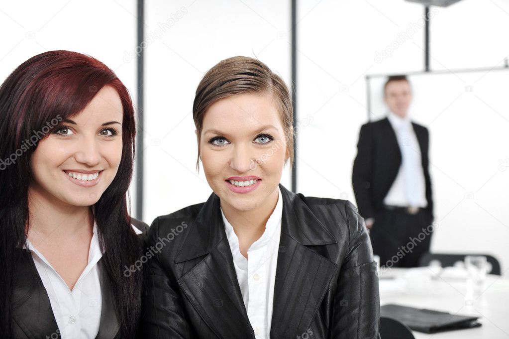 Portrait of two happy businesswomen in business presentation at office
