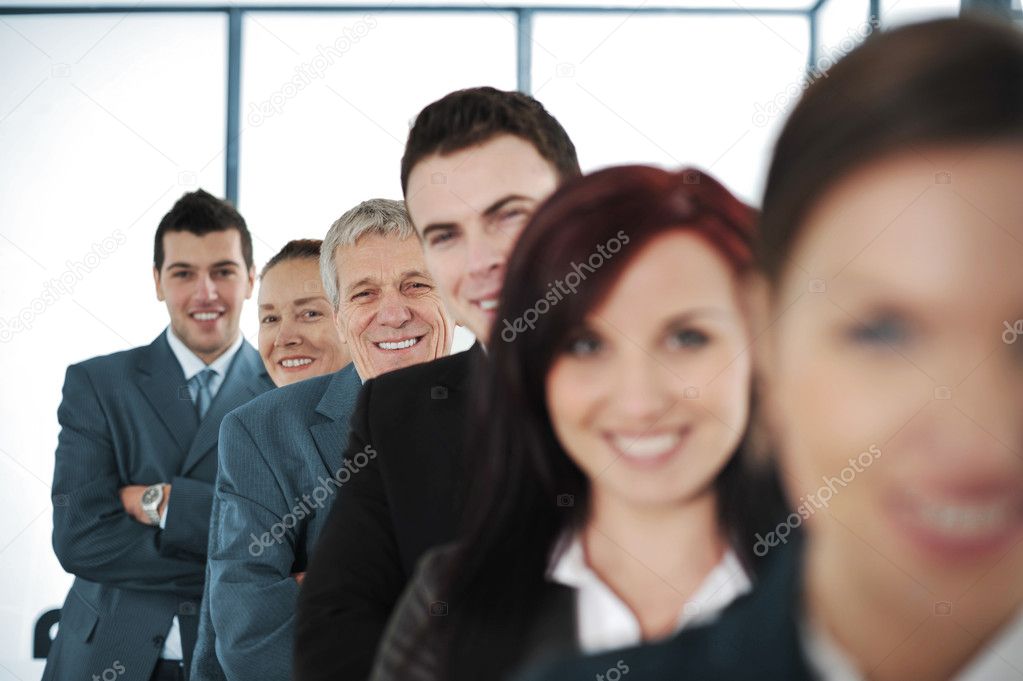 Six cheerful business standing in a row with their arms folded