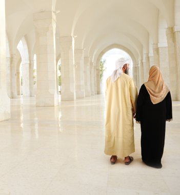 Muslim Arabic couple inside the modern mosque clipart