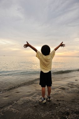 Child looking on the sea clipart