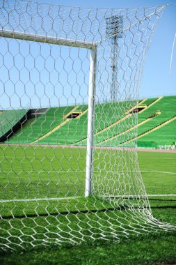 Goal net and white line in a soccer field on stadium clipart