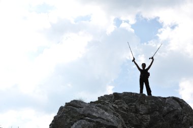 Silhouette of a woman during and adventage climbing and mountain walking clipart