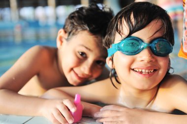 Havuzdaki mutlu çocuklar için yaz ve yüzme aktiviteleri