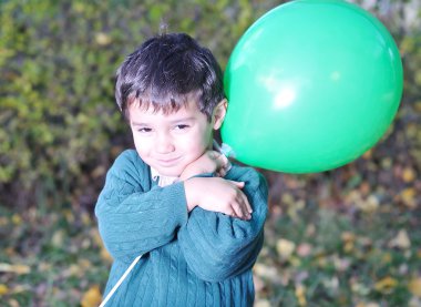 Happy positive cute kid outdoor, fall period