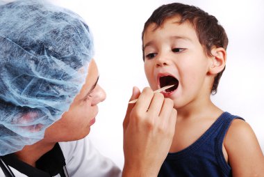 Young male doctor is taking care of little cute kid clipart