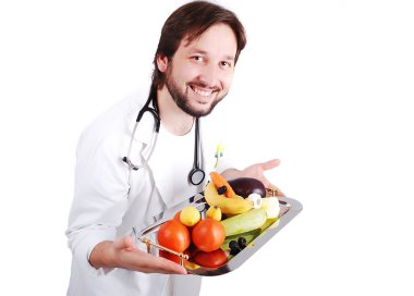 Young male doctor advicing healthy natural food clipart