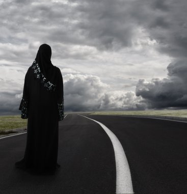 Muslim woman walking alone searching for the right path, conceptual image
