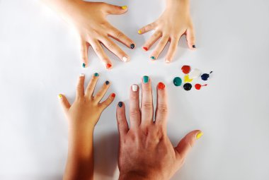 Children little hands playing with colors on white background clipart