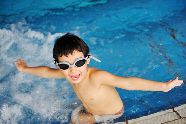 Happy child in a swimming pool