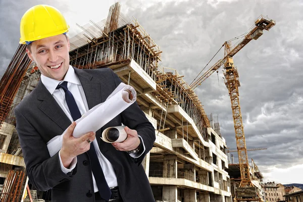 Engineer builder with blueprint at construction site — Stock Photo, Image