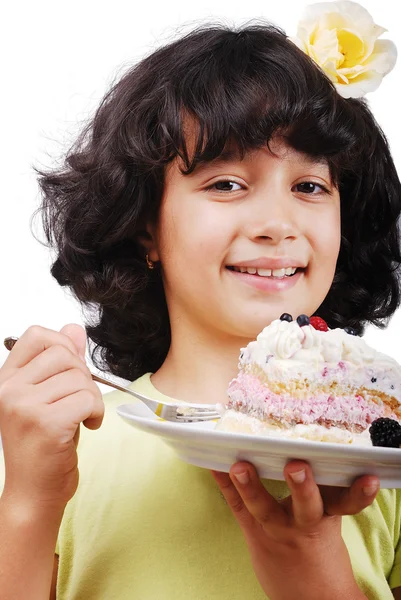 Jong meisje met roos in haar eten kleurrijke taart, geïsoleerd — Stockfoto